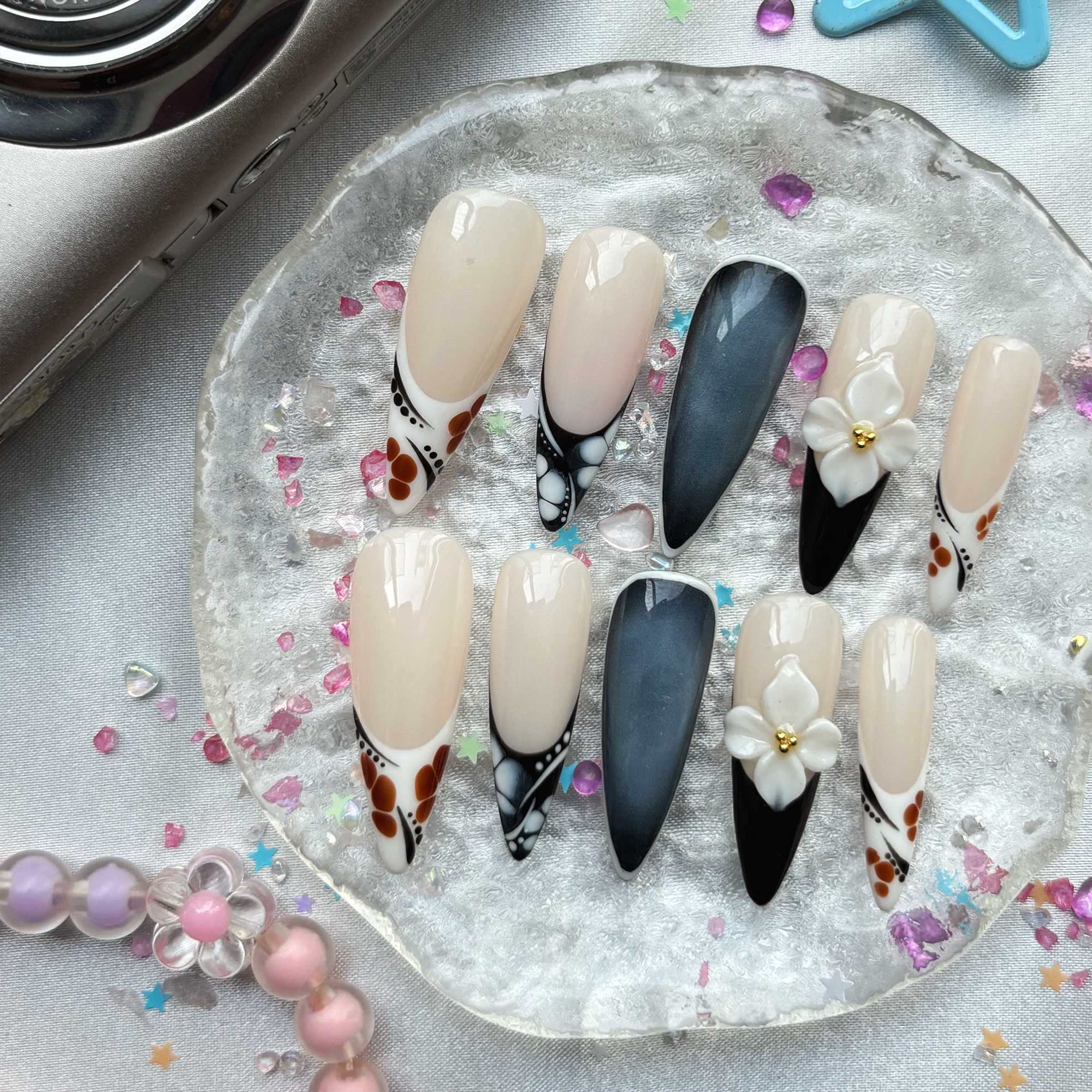 Personalized Nude & Black French Stiletto Nails | 3D White Flower | Abstract Dot Design | Modern Chic Nail Trend 2025